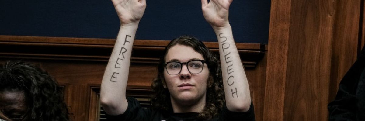 A demonstrator with Free Speech written on their forearms