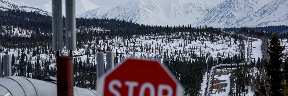 A Stop sign in front of a pipeline system in Alaska. 
