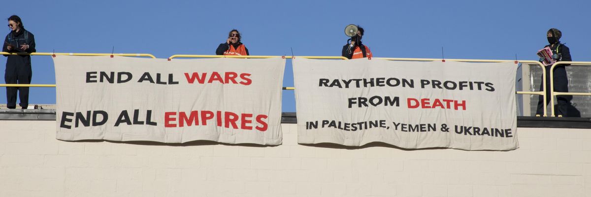 Activists occupy the roof of a Raytheon building