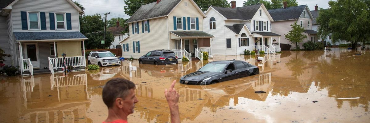 An evacuated resident points in the direction of his home following a flash flood, which came as Tropical Storm Henri made landfall, in Helmetta, New Jersey on August 22, 2021. (Photo: Tom Brenner/AFP via Getty Images)