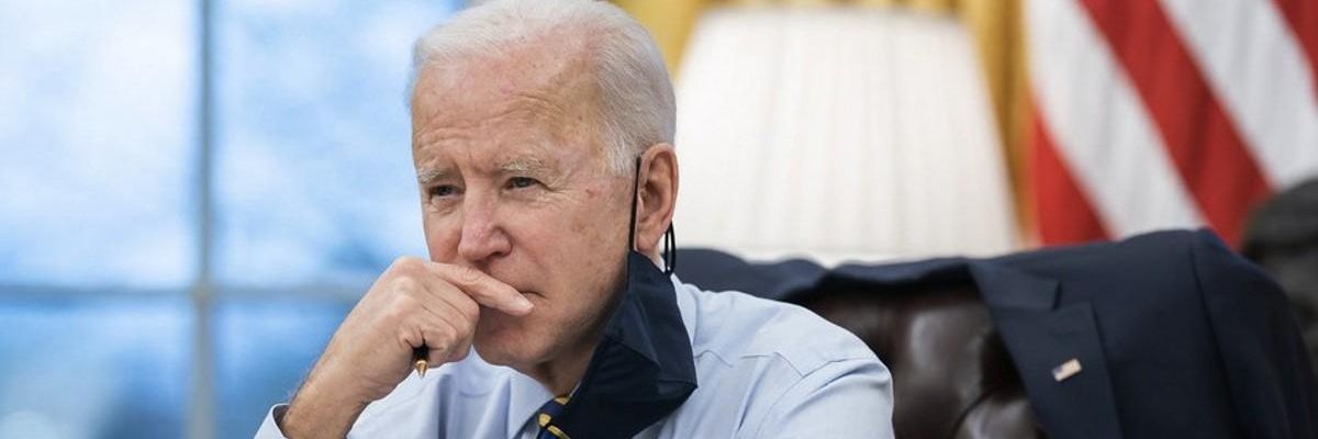 Biden with hand on face.
