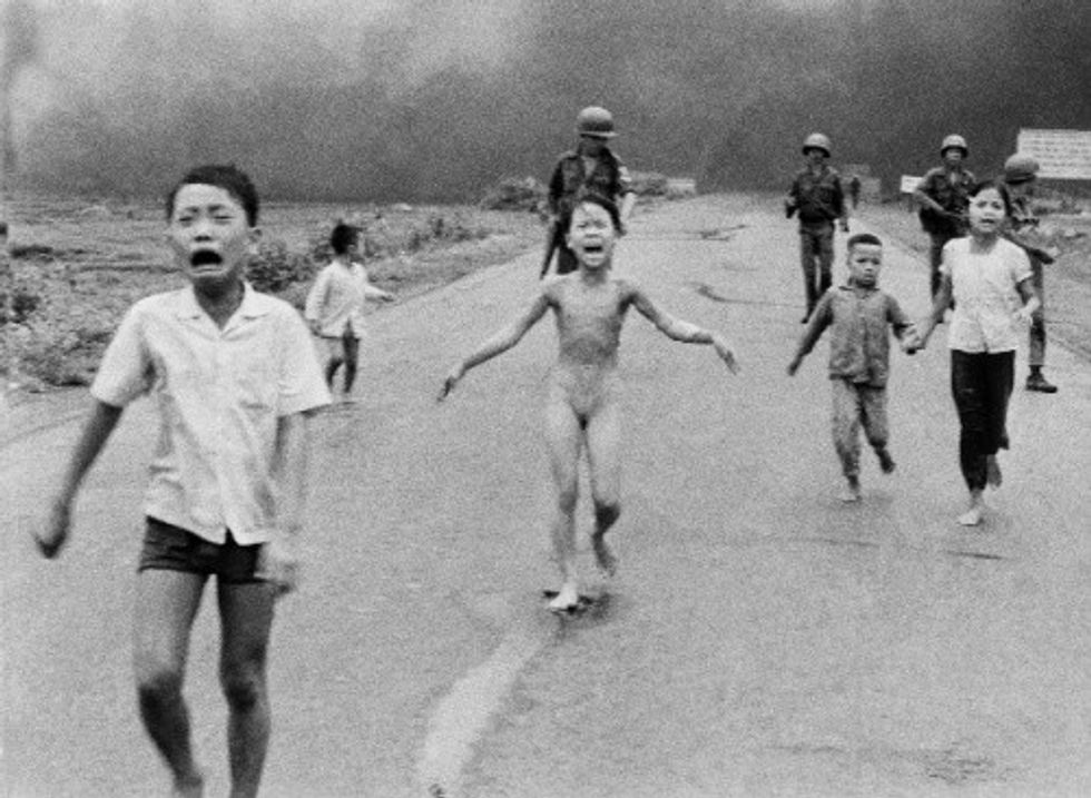 Children burned by American napalm during the Vietnam War run in terror 