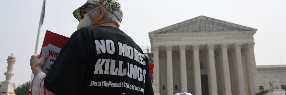Death penalty opponent wwaring t-shirt "No More Killing"