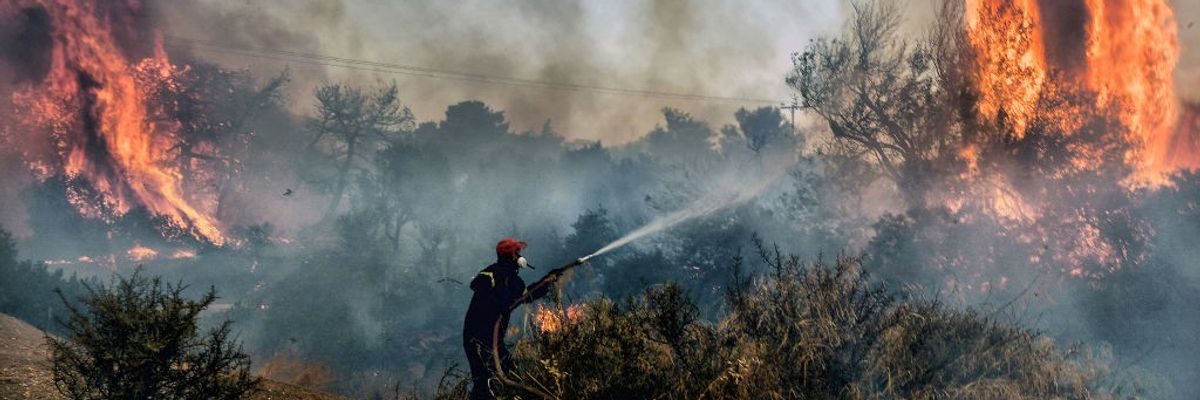 Fireman dousing flames in Greece