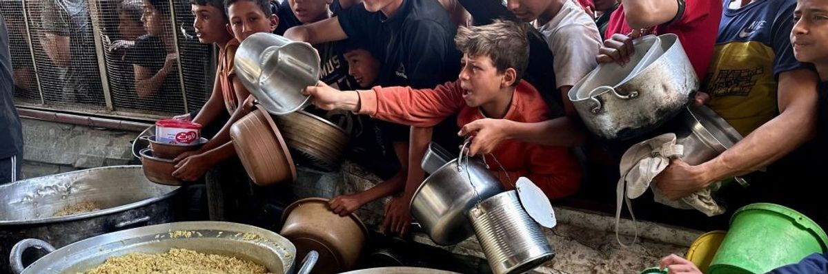 Hungry Palestinian children clamor for food aid in Gaza