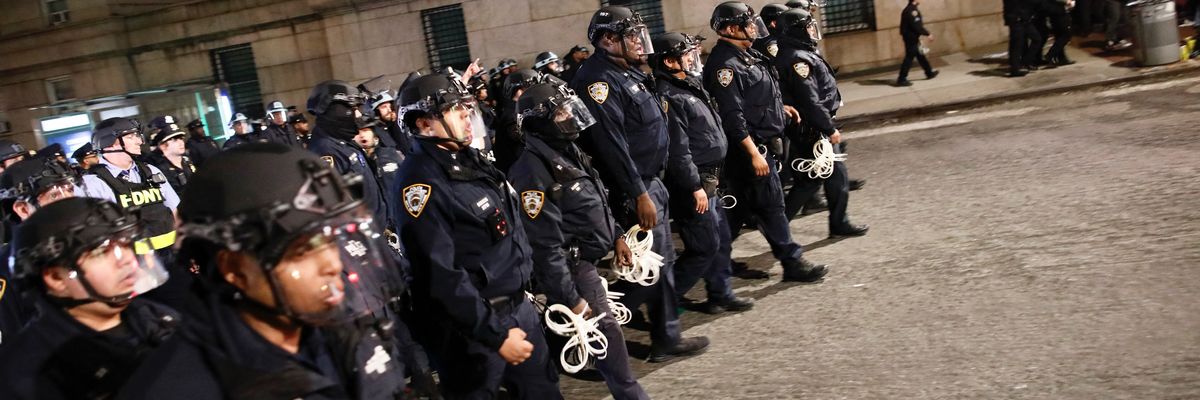 NYPD officers in riot gear march onto the Columbia University campus