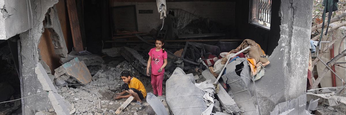 Palestinian children search rubble in Gaza.