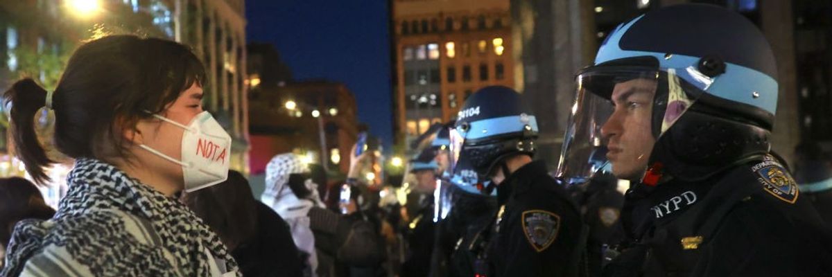 Pro-Palestinian protester faces NYPD officers near New York University