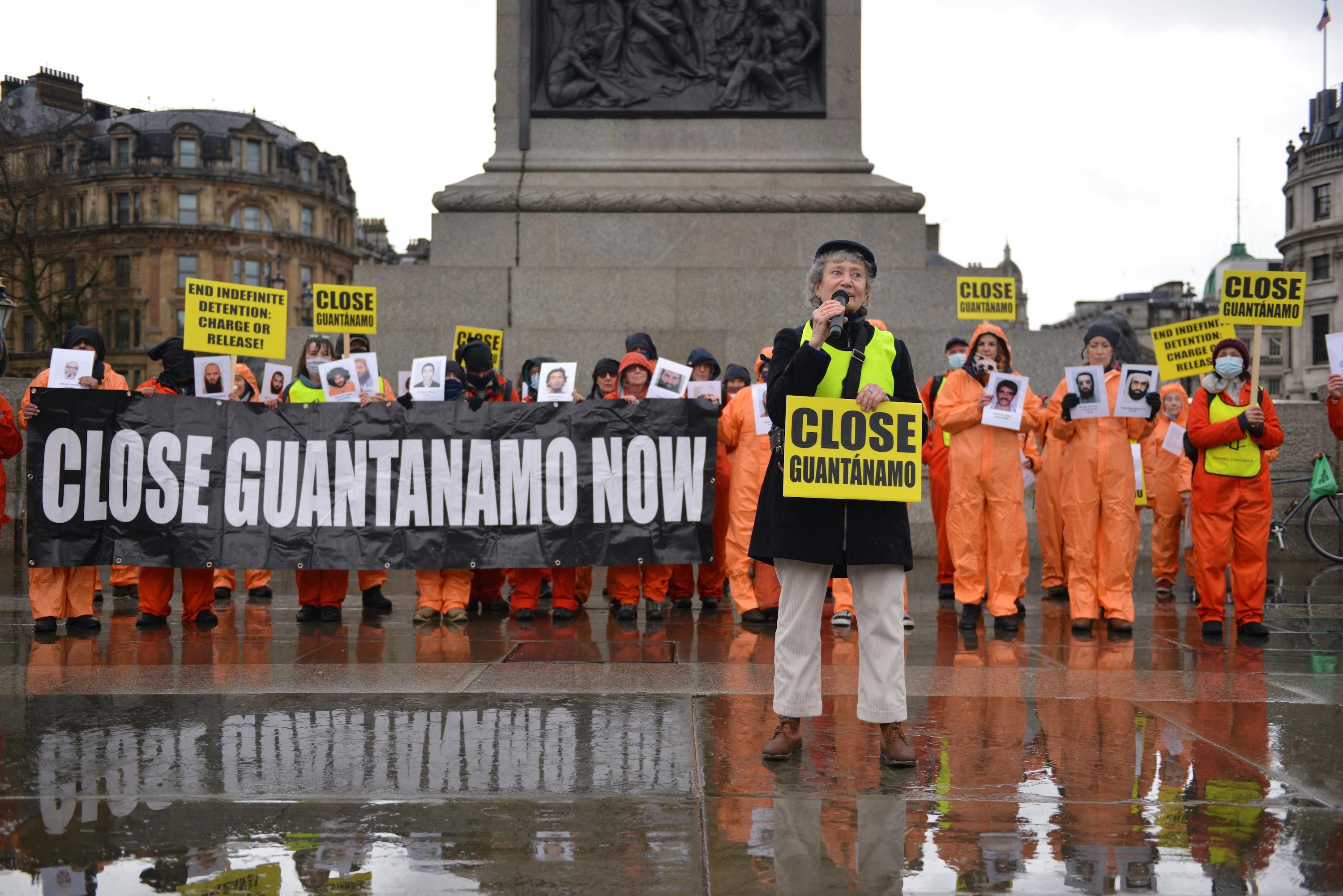  Amnesty International activists dressed in orange jumpsuits and hoods, representing the 39 men still held at Guantanamo